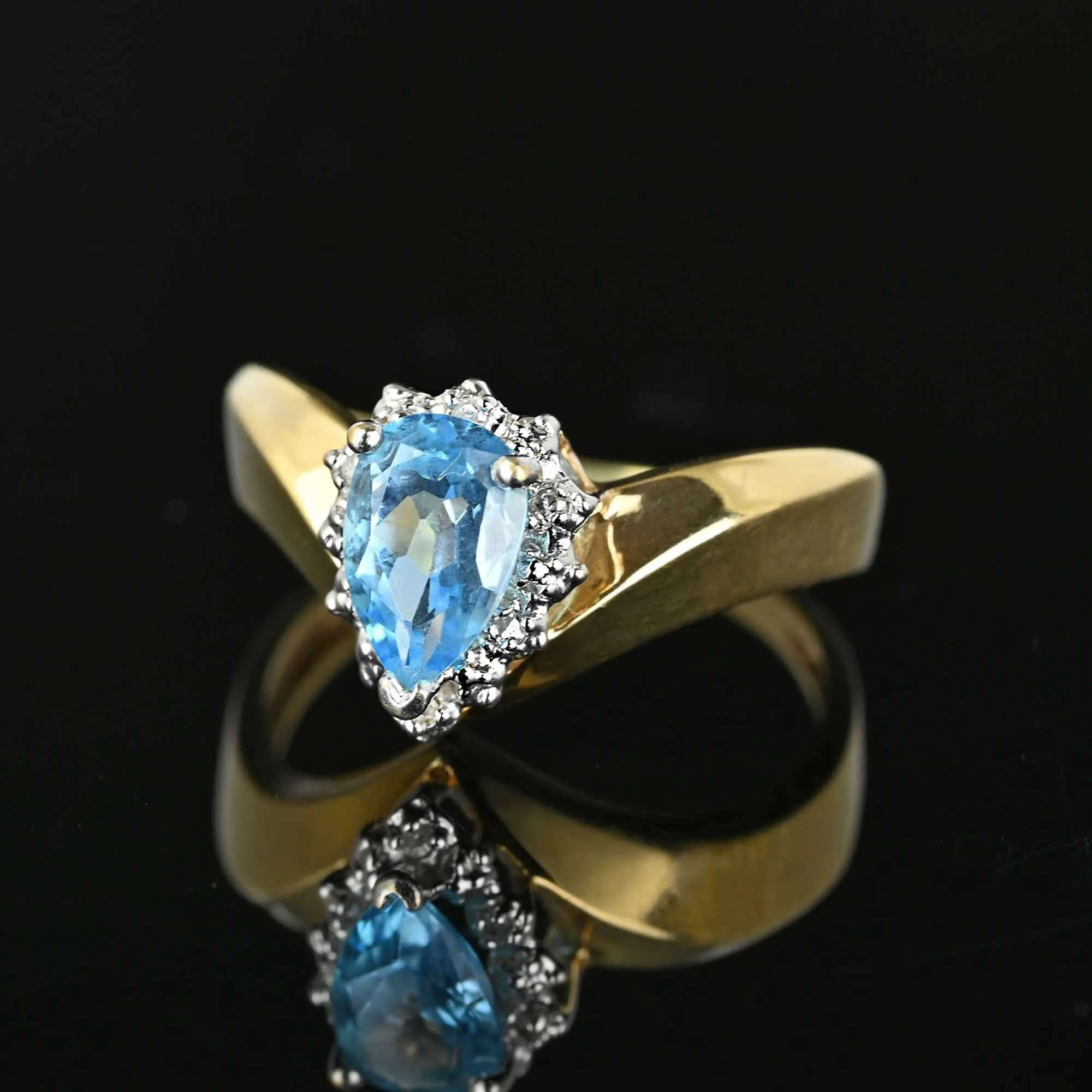 Diamond Halo Pear Cut Blue Topaz Ring in Gold